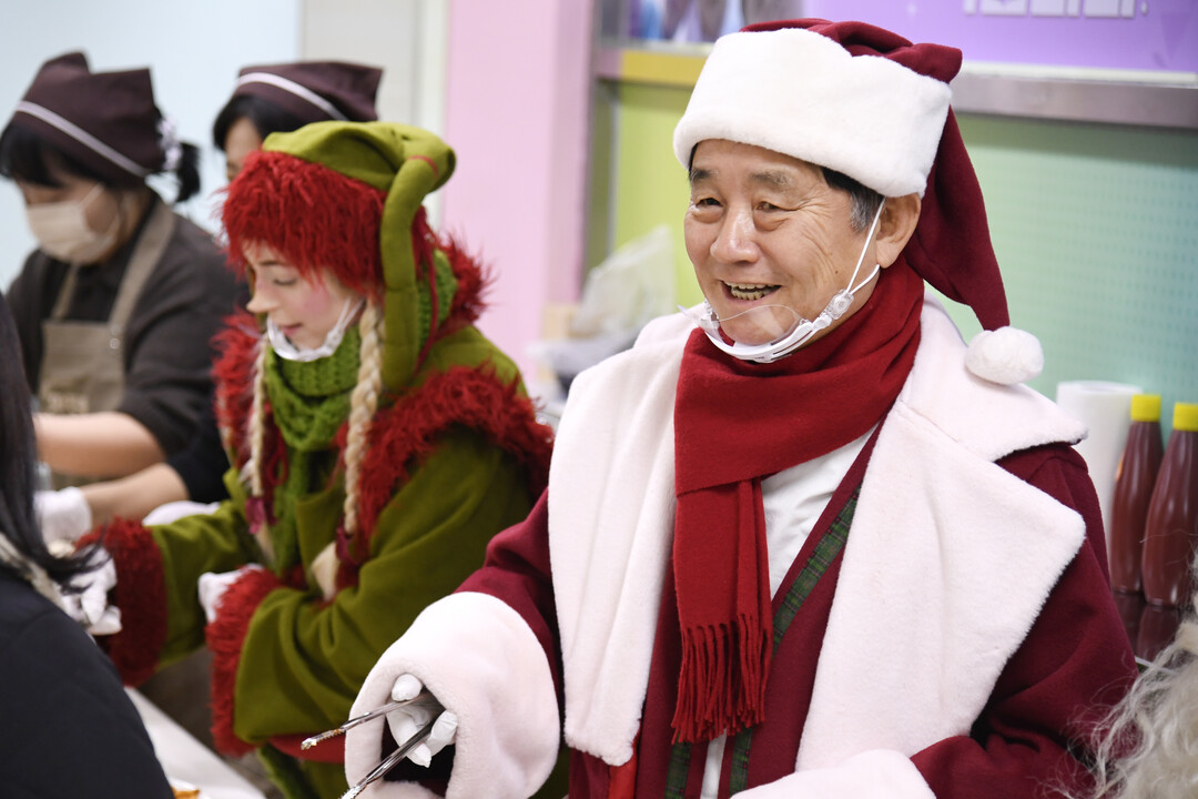 최문순 군수와 산타, 요정 엘프가 음식을 나눠주고 있다.