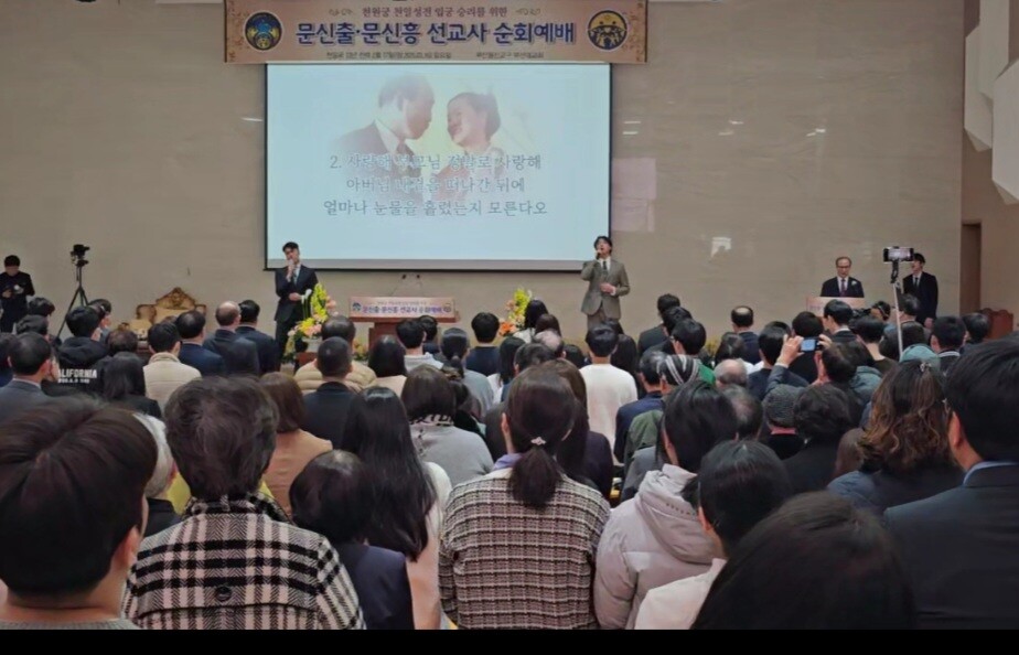 문신출·문신흥 선교사가 단상에 올라 ‘사랑해 참부모님’ 노래를 부산울산교구 순회예배에 참석한 가정연합 전체 식구들과 함께 열창하고 있다.