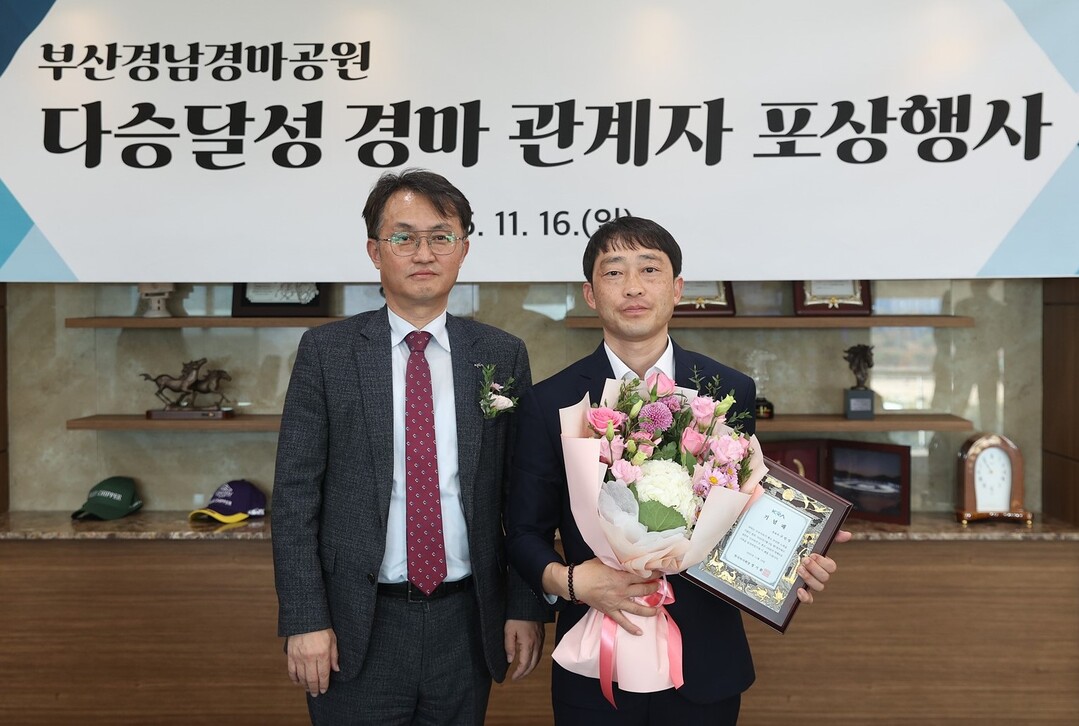 지난 16일 열린 다승 포상행사에서 엄영석(왼쪽) 한국마사회 부산경남지역본부장과 구민성 조교사가 기념촬영을 하고 있다. 렛부경 제공
